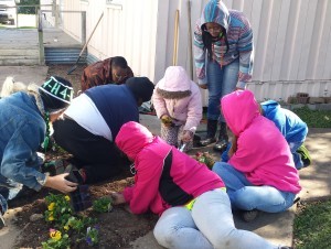 For their 2014 One Day 4-H project, members of the Grimes County Charm and Sewing Club planted flowers and painted the handicap ramps and rails, and cleaned the grounds at Greater First Missionary Baptist Church in Anderson. (Texas A&M AgriLife Extension Service photo)